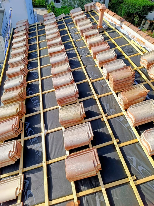 Bâtiment moderne en bois avec bardage vertical, toit à deux pans en tuiles terre cuite