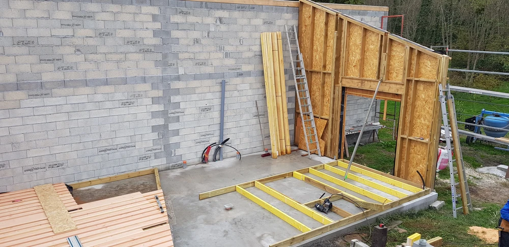 Bâtiment moderne en bois avec bardage vertical, toit à deux pans en tuiles terre cuite